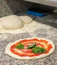 Margherita pizza about to get baked in marra forni rotator brick oven
