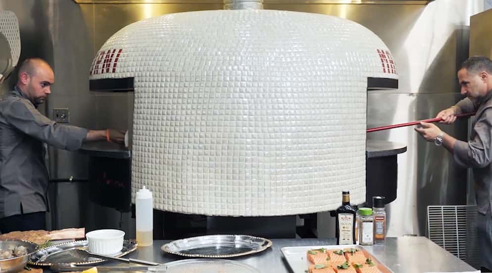 Two Chefs using Marra Forni Double Mouth Rotator White Tiled Oven cooking pizza