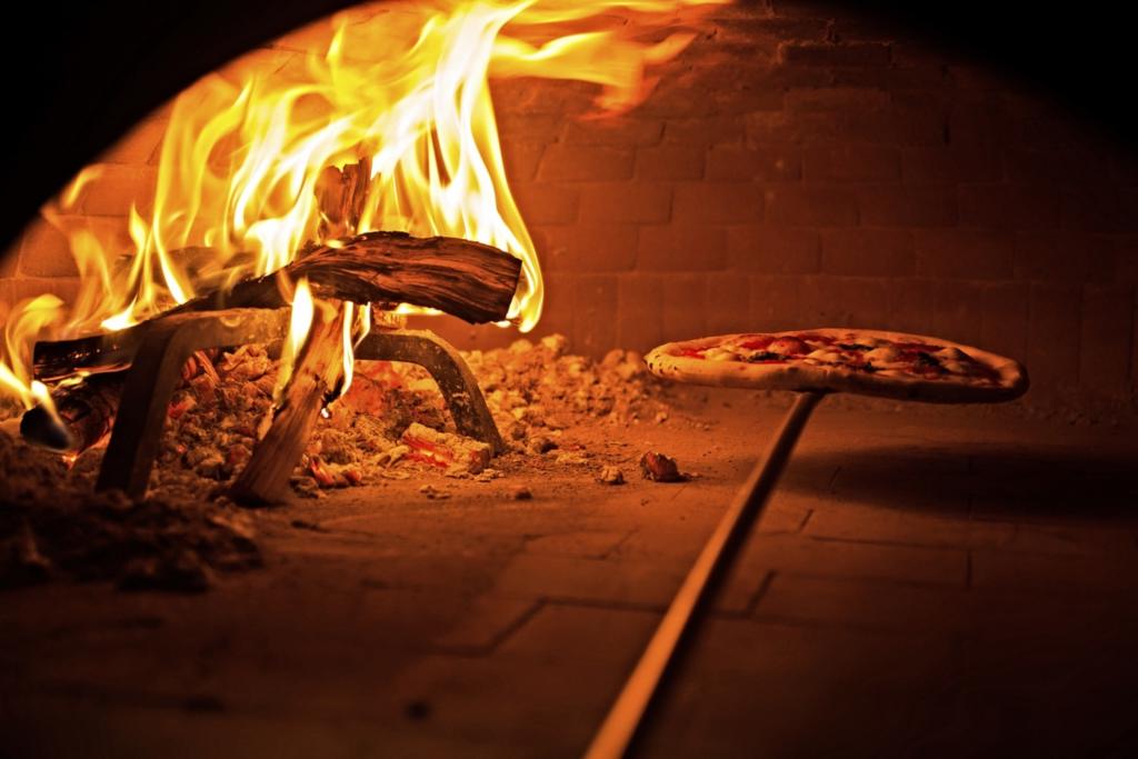 Wood Fired Pizza on peel inside oven