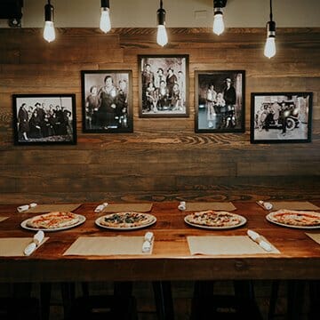 Four Pizzas lined up on dinner table in Moroso Wood Fired Pizzeria